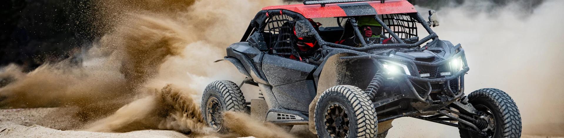 Image of a Side X Sides vehicle in a cloud of dust